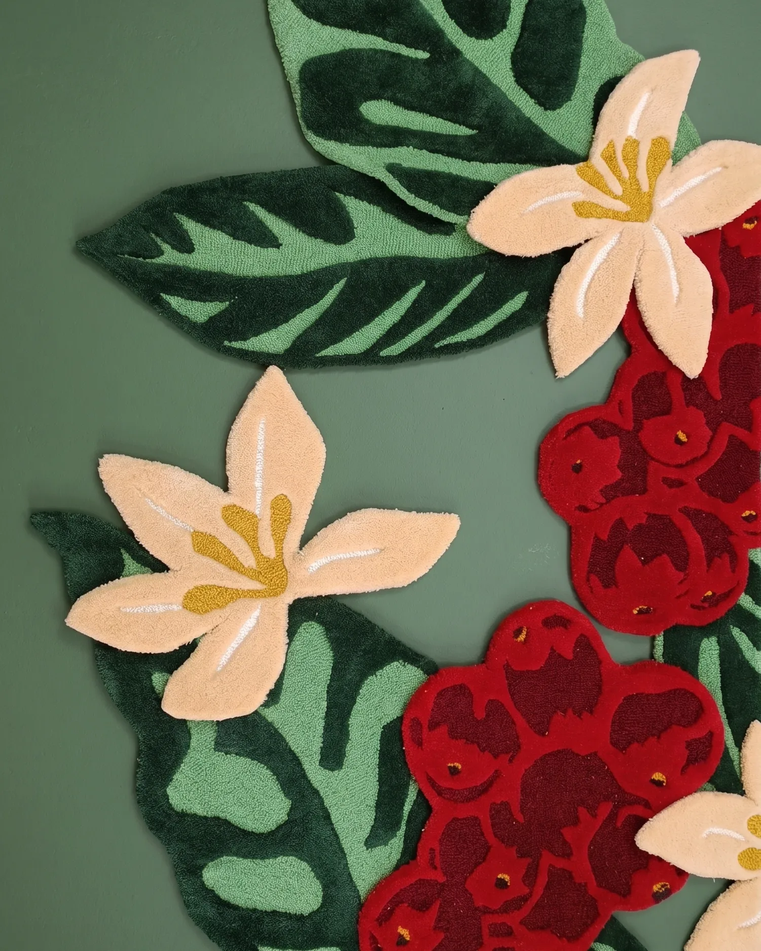 Detail of the hand-tufted woollen coffee cherries, flowers and leaves at Starbucks Rajpur Road, Dehradun